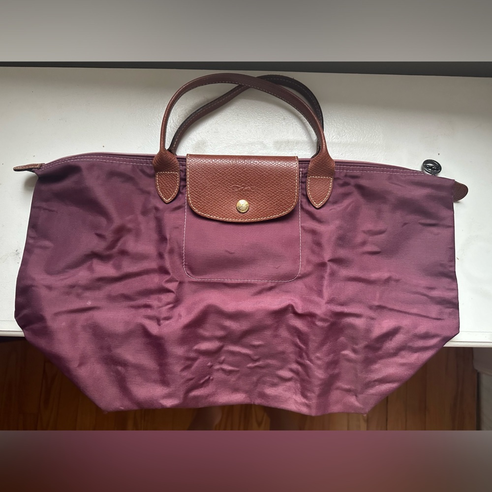 Used Large pliage longchamp bag. Short Handle. Purple. Authentic. Used.